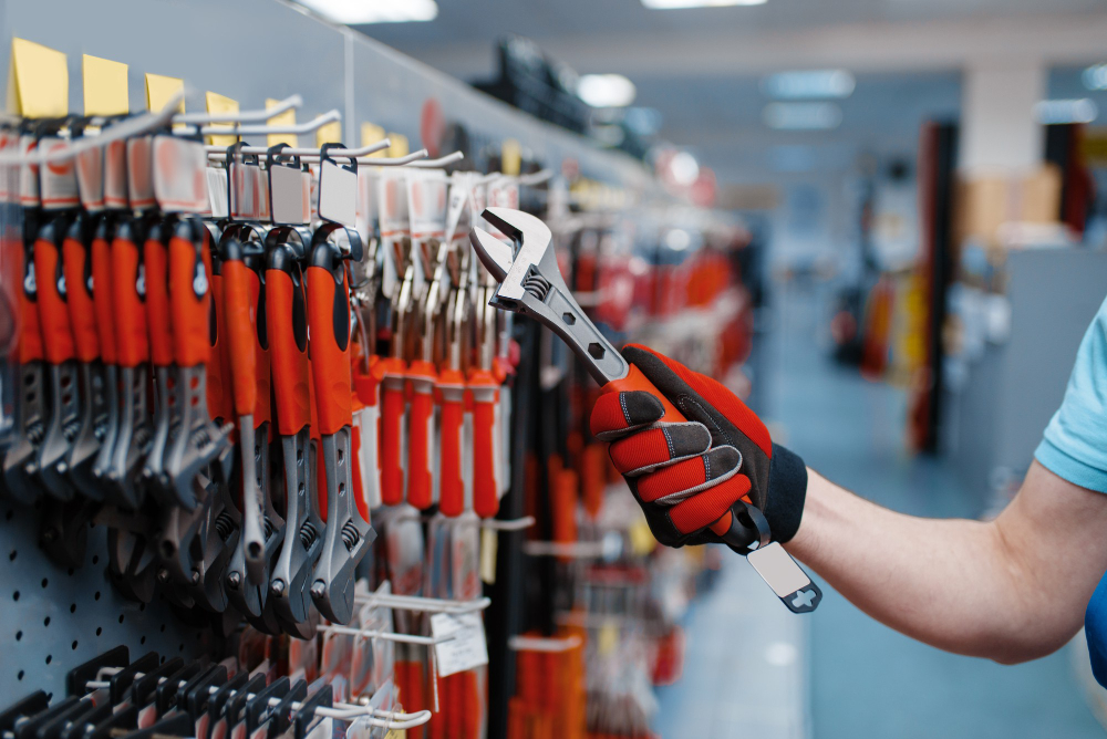 חנות כלי עבודה male-worker-uniform-choosing-adjustable-wrench-tool-store-choice-professional-equipment-hardware-shop-instrument-supermarket